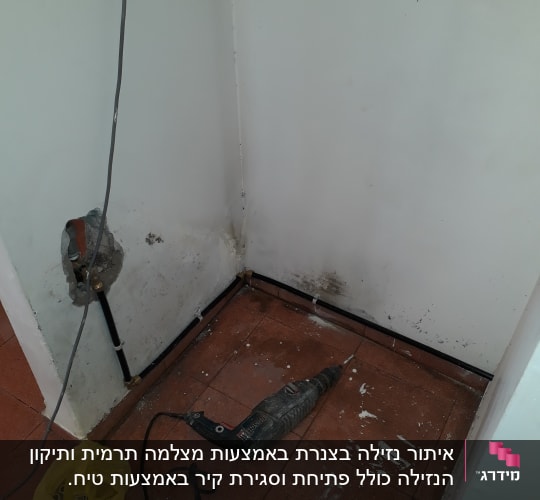 קיר עם סימני רטיבות, מקדחה על הרצפה